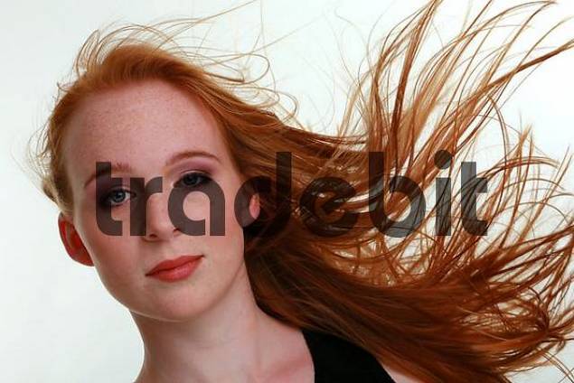 Girl With Red Hair And Freckles. Portrait of a girl with moving red hair and freckles
