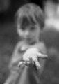 Thumbnail A little boy hold an earthworm in his dirty hand
