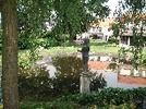 Thumbnail Reflecting pond and statues in a green garden