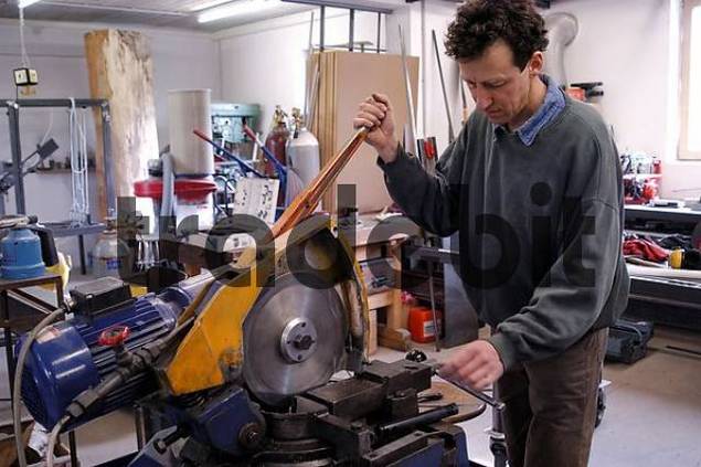 craftsman at working in garage for metall - Download People